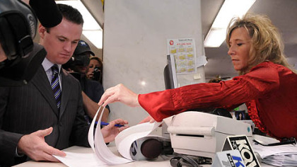 Allegheny County Department of Court Records clerk Laurie Streng, right, shows Pittsburgh Mayor Luke Ravenstahl where to sign the paperwork to temporarily change his name to Steelerstahl.