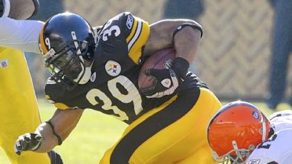 The Steelers' Willie Parker tries to grind out some distance as the Browns' D'Qwell Jackson works to slow him down in the first quarter Sunday.