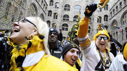 Members of Steeler Nation flooded into the courtyard at the Allegheny County Courthouse during a rally yesterday to support the team in its upcoming playoff game against the San Diego Chargers. From left are Michelle Kernan of Moon, Darren Long of Jefferson Hills and, wearing Steelers beads, cap and glasses, Don Zadach of Jefferson Hills.