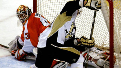 Flyers goalie Martin Biron tries to fill the net anyway he can, but he can't prevent Matt Cooke from giving the Penguins a 4-1 lead late in the second period last night at the Wachovia Center in Philadelphia.