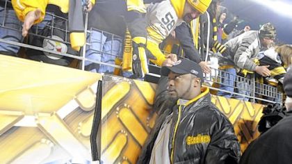Steelers head coach Mike Tomlin shakes hands with fans as he leaves the field after the Steelers win over San Diego in the first playoff game.