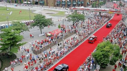 Spectators watch as All-Star players are driven to Busch Stadium before the game.