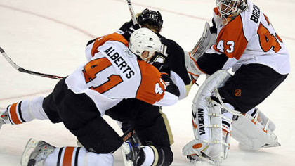 Jordan Staal is sandwiched between Flyers Andrew Alberts and goaltender Martin Biron in overtime.