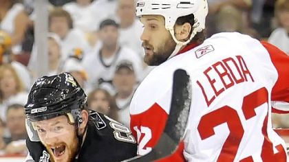 Matt Cooke, left, fights for position with Detroit's Brett Lebda.