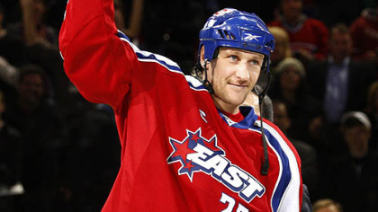 Eastern Conference's Alex Kovalev, of the Montreal Canadiens, holds up the MVP trophy after the game last night.