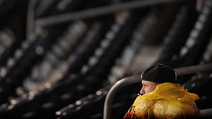 Pirates fans wait for a rain delay to end.