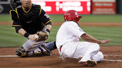 Phillies outfielder Shane Victorino beat the tag of Pirates catcher Ryan Doumit to score on a single by second baseman Chase Utley in the third inning of last night's game.