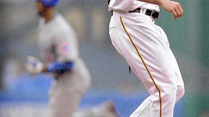 Cubs first baseman Derrek Lee rounds the bases behind Pirates pitcher Daniel McCutchen after hitting a two-run homerun during the third inning yesterday at PNC Park.