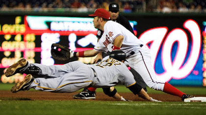 Freddy Sanchez slides to first base  as Washington Nationals' first baseman Nick Johnson make the play and out during the seventh inning of last night's game in Washington.