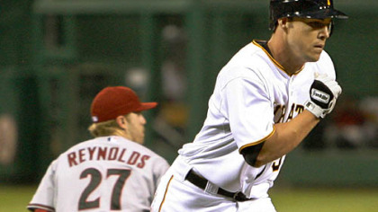 Pirates pinch hitter Steve Pearce runs home after Diamondbacks catcher Miguel Montero threw the ball over the head of third baseman Mark Reynolds in the sixth inning.