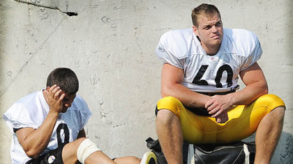 Punter Daniel Sepulveda, left, sits out the afternoon practice at Saint Vincent College at camp last year the day after his injury.