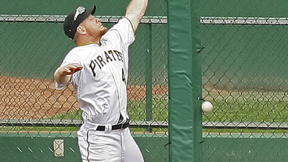 Pirates left fielder Brandon Moss can't get to a ninth-inning triple hit by Brewers outfielder Mike Cameron.