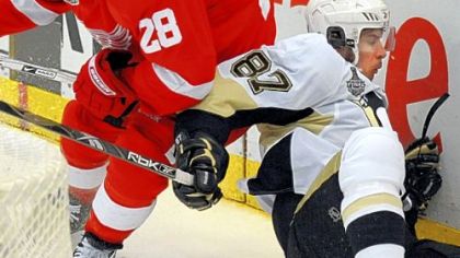 Detroit's Brian Rafalski knocks Sidney Crosby to the ice midway through last night's Game 2 at Joe Louis Arena in Detroit.