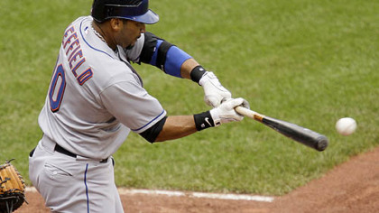 Mets outfielder Gary Sheffield drives in teammate Alex Cora with a fifth-inning single off Pirates pitcher Paul Maholm yesterday.