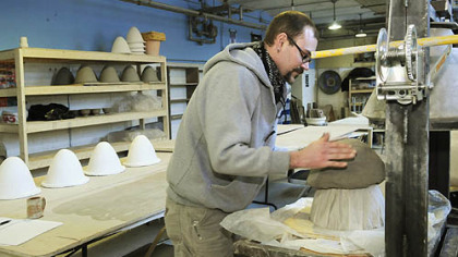 Jeff Schwarz places a clay mixture on the mold, forming a cone. The cone is fired at 1,700 degrees. When finished, it acts as a natural filter for contaminated water.