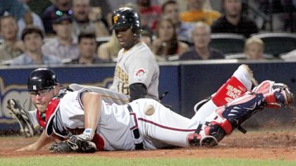 Atlanta catcher Brian McCann can't handle the throw from second base, allowing Craig Monroe to score on Adam LaRoche's single in the seventh inning.