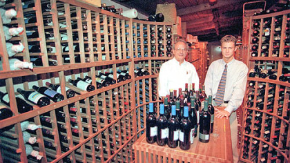 The Wooden Angel was started in 1948 by Alex Sebastian, left, and is now owned by his son, Alex Jr. They are shown in the wine cellar.