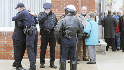 Police embrace outside the Winter Funeral Home in Bloomfield during visitation for fellow officer Paul J. Sciullo II.