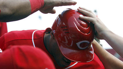 Reds outfielder Darnell McDonald is congratulated by teammates after scoring the winning run on a wild pitch from Pirates pitcher Jesse Chavez in the bottom of the ninth inning of the first game.