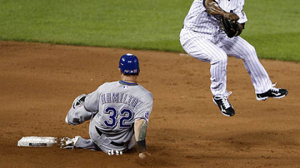 Rangers outfielder Josh Hamilton is out at second base as Astros shortstop Miguel Tejada turns a double play on a ball hit by Rangers infielder Michael Young during the sixth inning.