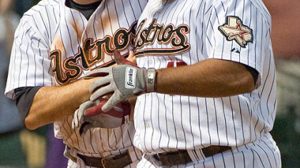 Astros first baseman Lance Berkman, left, celebrates with outfielder Carlos Lee after the pair scored on Lee's three-run home run during the seventh inning.