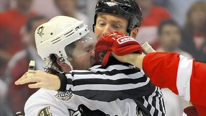 Matt Cooke takes a left from Detroit's Johan Franzen during one of the many third-period scrums.