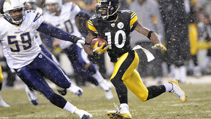 Santonio Holmes returns a punt back for a touchdown in the first quarter against the Chargers Sunday.