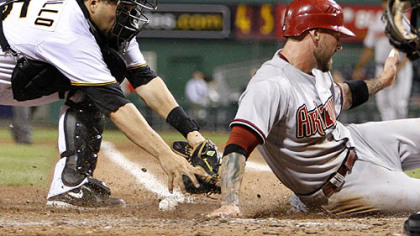 Pirates catcher Jason Jaramillo loses the ball as he attempts to tag Diamondbacks infielder Ryan Roberts in the eighth inning.