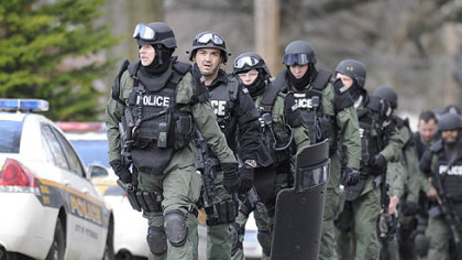 Pittsburgh police file up Fairfield Street following a deadly stand-off in Stanton Heights today,.