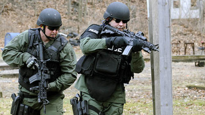 City SWAT members William Friburger and Donald Savko practice at the shooting range in Highland Park. The team's performance in a sniper competition last year will air on the Military Channel tomorrow and Tuesday nights.
