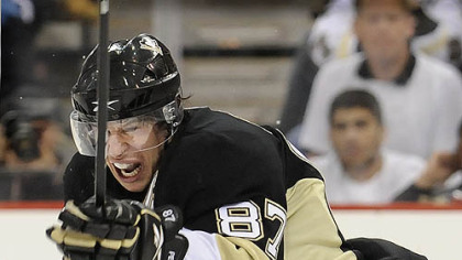 Sidney Crosby battles against through a Flyers' stick in the first period last night at Mellon Arena.