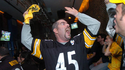Marc "Bubba" Snider, owner of Ugly bar on the North Side, celebrates a playoff win in January 2005.