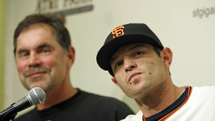 New Giants infielder Freddy Sanchez, right, answers questions as manager Bruce Bochy smiles during a news conference at AT&T Park in San Francisco yesterday.