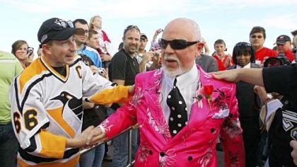 CBC analyst Don Cherry, sporting a customary loud outfit, greets a Penguins fan as he enters Joe Louis Arena for last night's Game 2 in Detroit.
