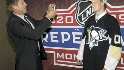 Philip Samuelsson, right, has his picture taken by a familiar face to Pittsburgh fans, his father, Ulf. Philip was taken in the second round by the Penguins, his dad's former team, yesterday in Montreal.