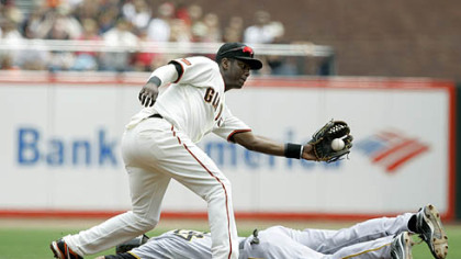 Pirates outfielder Garrett Jones steals second base and beats the throw to Giants shortstop Edgar Renteria during the second inning.