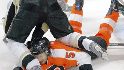 Evgeni Malkin goes tumbling over Philadelphia's Braydon Coburn in front of the Flyers' net.