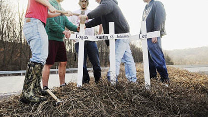 Meyersdale Area High School students Tyler Sechler, Detrick Peterman, Jonathan McKinney, Shawn Baer and Josh Hay erect crosses in memory of their classmates and teammates Lee Gnagey, Austin Johnson and Logan Buterbaugh, who died in a car crash at the site.