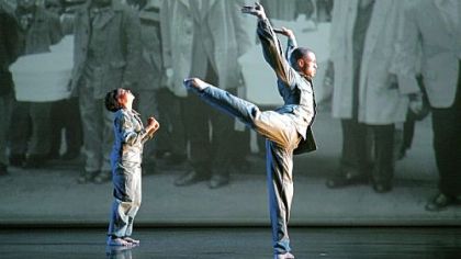 Tiffany Quinn and Keon Thoulouis of the Ronald K. Brown/Evidence Dance Company perform in front of Charles "Teenie" Harris' "Mourners and pallbearers with three caskets outside West's Funeral Home next to Lew's Loan Office."