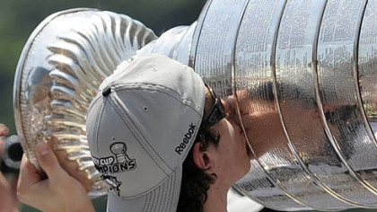 Center Evgeni Malkin shows some love to the Stanley Cup he helped bring back to Pittsburgh.