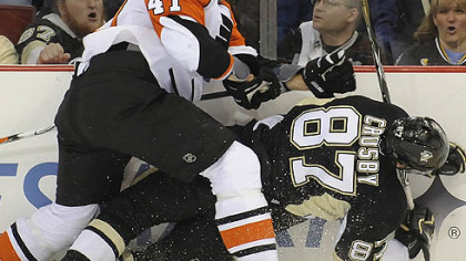 The Flyers' Andrew Alberts checks Sidney Crosby into the boards in the second period last night.