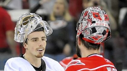 Goalie Marc-Andre Fleury shakes hands with Hurricanes goalie Cam Ward after defeating Carolina last night at the RBC Center in Raleigh, N.C.
