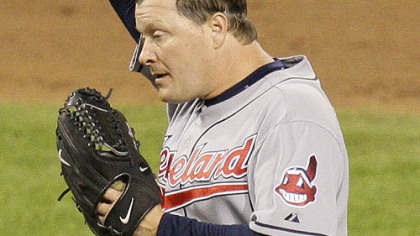 Indians pitcher Matt Herges wipes his head while standing on the mound during the ninth inning.