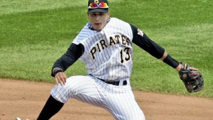 Pirates shortstop Ronny Cedeno leaps over the Cardinals' Brandon Ryan to complete a double play.