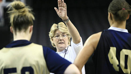 Pitt's coach Agnus Berenato talks to Kate Popovec, left, and Pepper Wilson, right, during practice in Oklahoma City, Saturday.