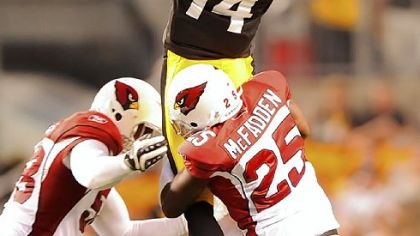 Receiver Limas Sweed leaps high in to the air and picks up a first down against the Cardinals in the first quarter last night at Heinz Field.