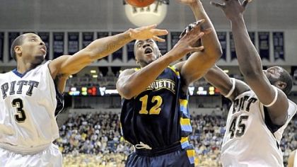 Jermaine Dixon and DeJuan Blair fight for a loose ball with Marquette's Dwight Burke in the second half last night.