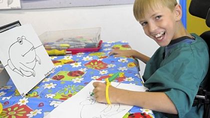 Alex McKay, 12, paints during his art class at Monart School of Art.