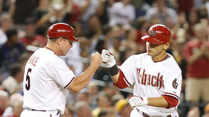 Diamondbacks outfielder Gerardo Parra, right, gets a high five from third base coach Chip Hale after hitting a two-run home run in the fifth inning.