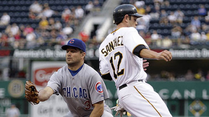 Freddy Sanchez scores all the way from second base on a wild pitch as the Cubs' Ted Lilly is unable to hang on to catcher Geovany Soto's throw in the fourth inning.